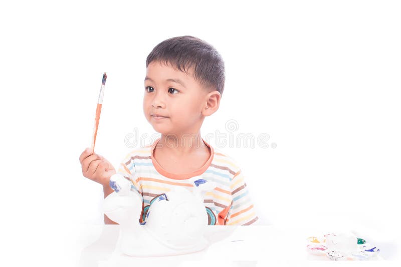 Cute little boy playing with paints royalty free stock image