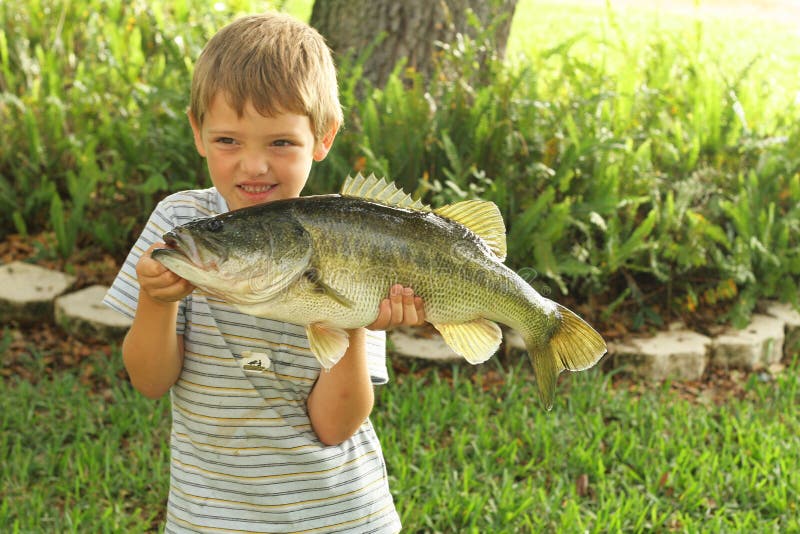 Cute little boy showing off his bass