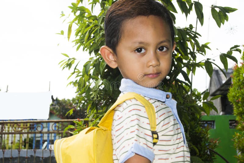 Cute Little Boy Standing Looking Sideways Wearing Yellow School Bag ...