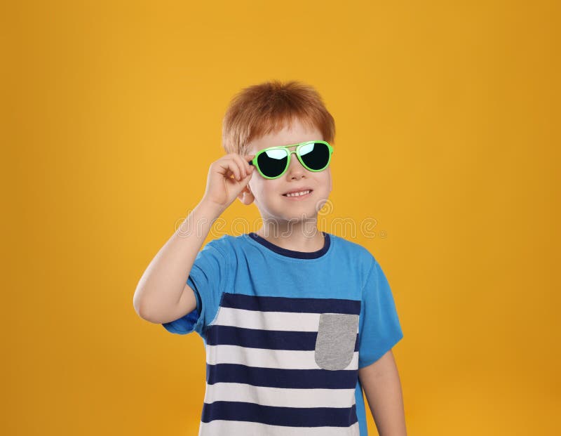 Cute Little Boy with Sunglasses on Light Blue Background Stock Photo