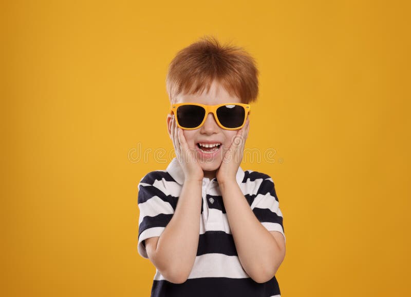 Cute Little Boy with Sunglasses on Light Blue Background Stock Photo