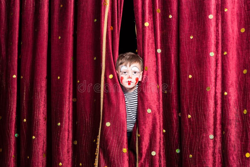 Cute little boy wearing face paint and a costume