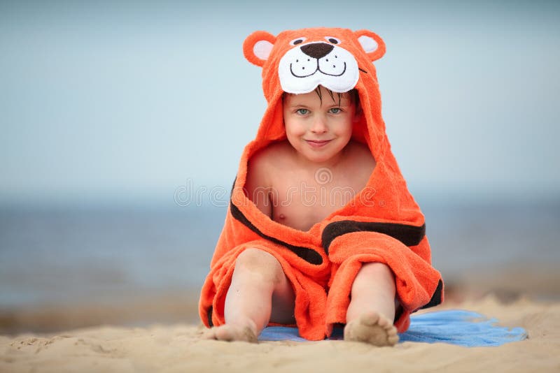 Cute little boy wearing tiger towel outdoors stock image Cute little boy wearing tiger towel outdoors stock image