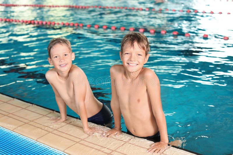 Cute little boys in indoor pool royalty free stock photos