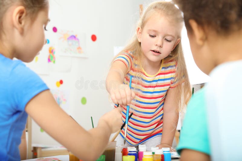 Cute little children painting at lesson stock image Cute little children painting at lesson stock image