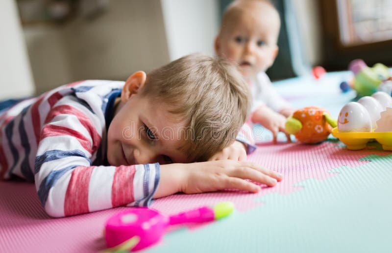 Cute Little Children Playing while Sitting on Carpet Stock Image ...