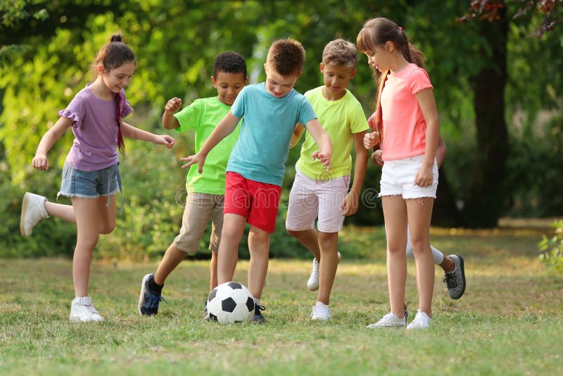 Cute little children playing with soccer ball royalty free stock images