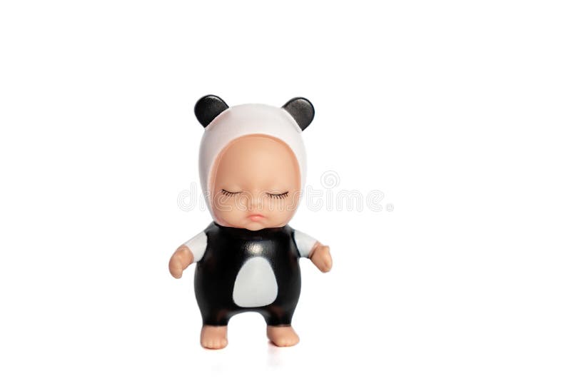 Cute little doll in a panda costume with closed eyes.Stands on a white isolated background.Collection of toys.Soft focus