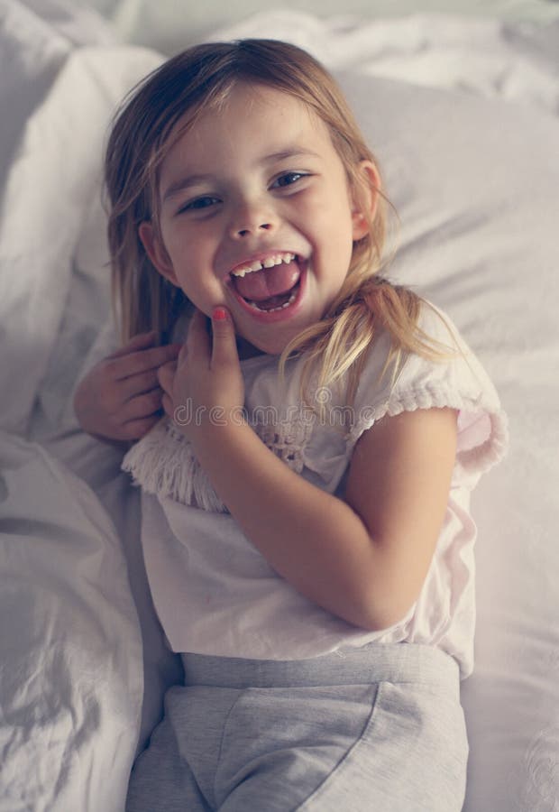 Cute little girl in bed. stock image. Image of little 98434681