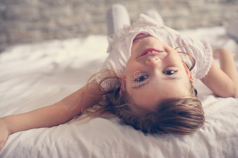 Cute little girl in bed.