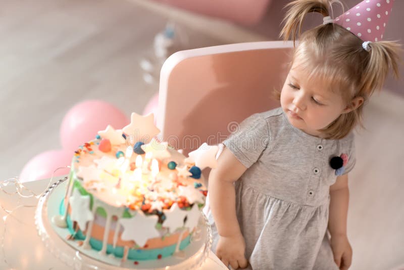 Cute Little Girl with Birthday Cake Sitting on Chair in Room Stock ...