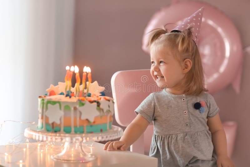 Cute Little Girl with Birthday Cake Sitting on Chair in Room Stock ...