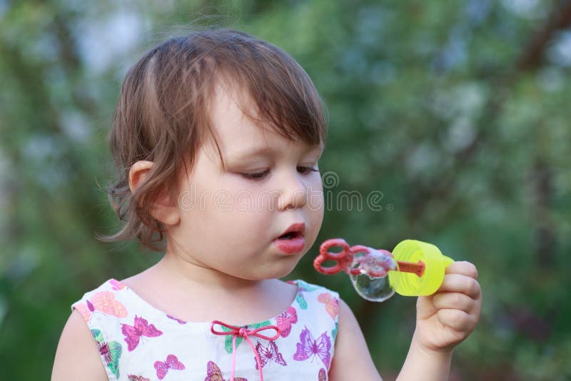 Cute little girl is blowing a soap bubbles royalty free stock photo Cute little girl is blowing a soap bubbles royalty free stock photo