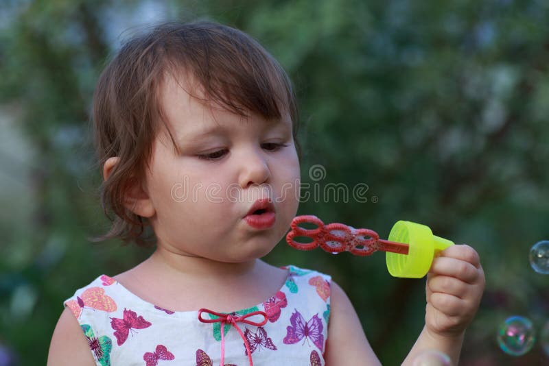 Cute little girl is blowing a soap bubbles royalty free stock photos Cute little girl is blowing a soap bubbles royalty free stock photos