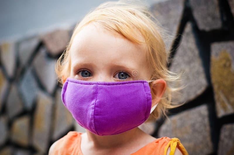 Cute little girl in bright face mask