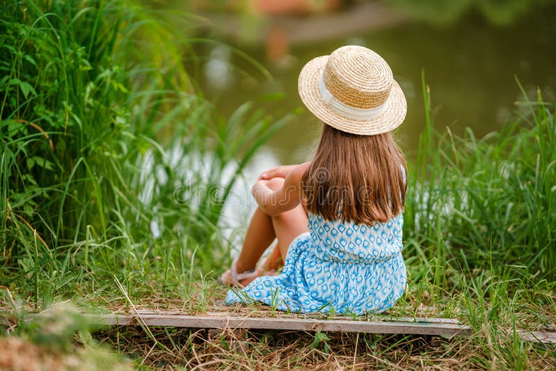 Cute Little Girl Child in a Hat and Dress on the Shore of a Fabulous Lake  with a Summer Green Background Stock Photo - Image of horizontal, beauty:  228032286