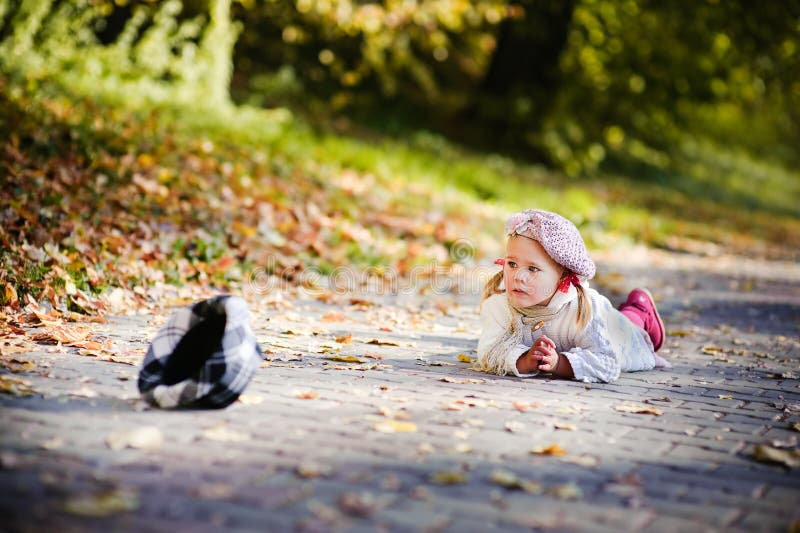 Cute little girl crying in autumn park