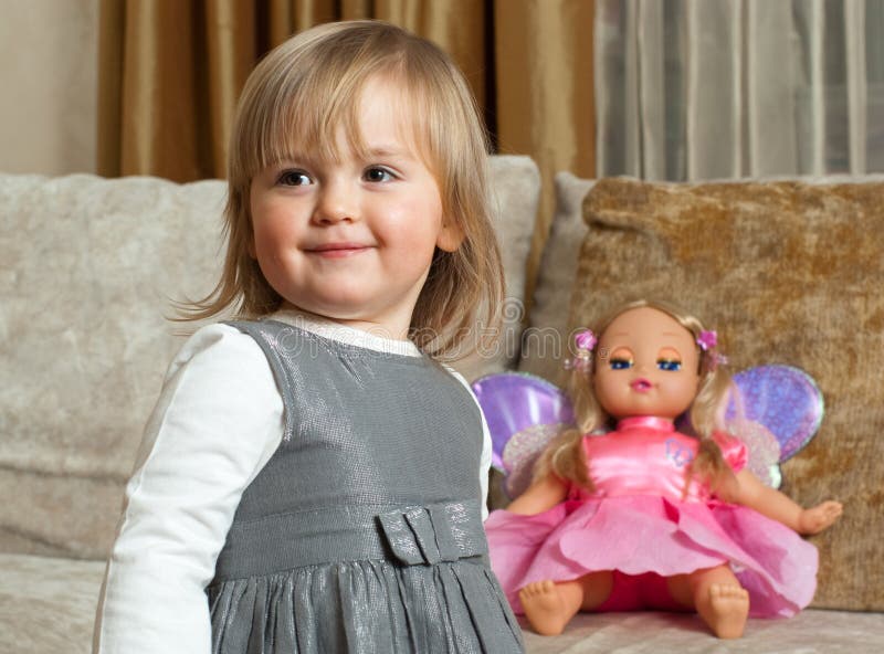 Cute little girl and a doll