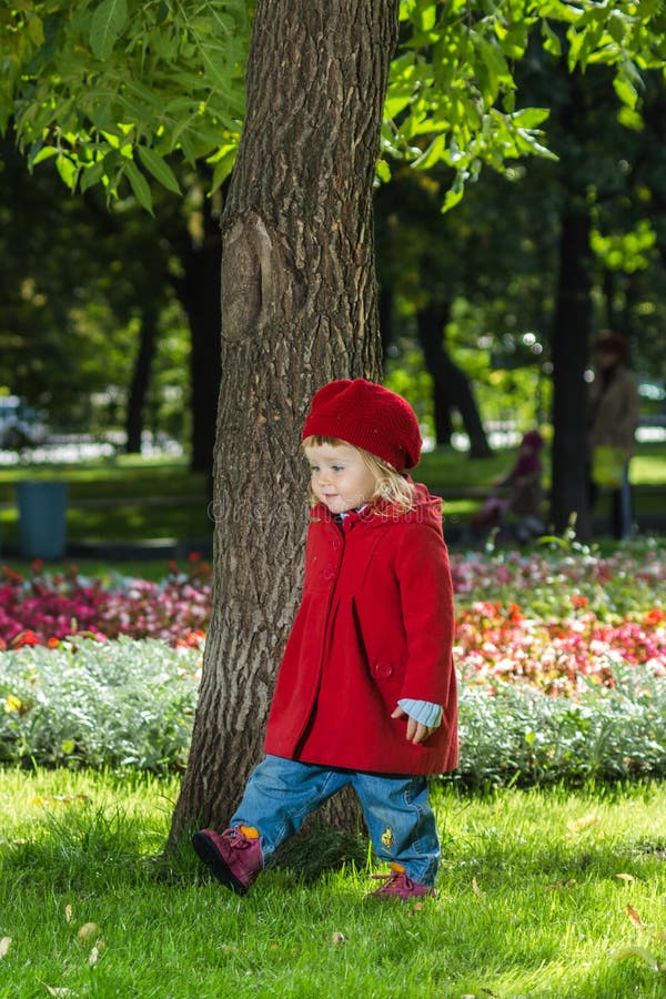Cute little girl dressing in red coat royalty free stock images