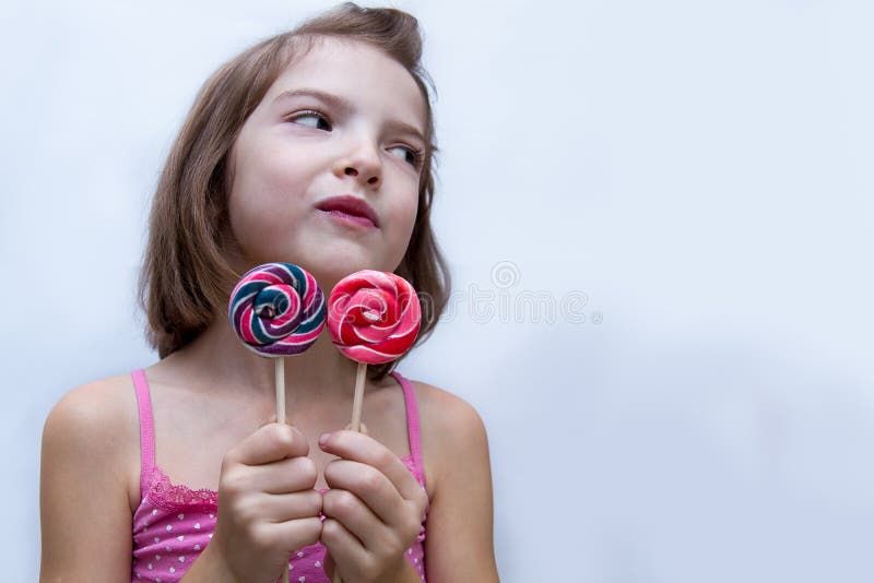 Beautiful cute little girl eating lollipop royalty free stock photos Beautiful cute little girl eating lollipop royalty free stock photos