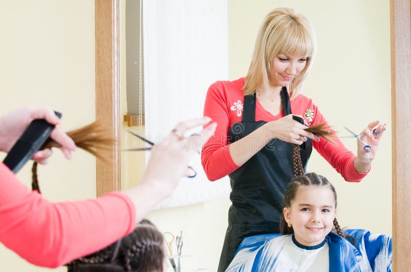 Cute little girl in hairdresser salon