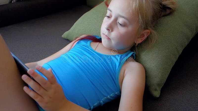 Cute Little Girl Holding Digital Tablet Lying in Bed. Teen Girl Playing on Tablet Pc. Stock Footage - Video of computer, casual: 151238400 