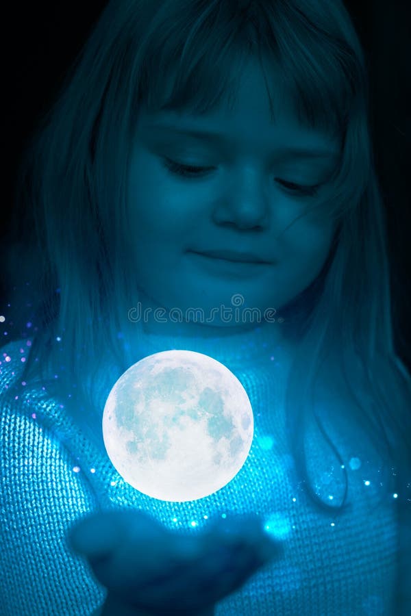 Little girl holding the moon and stars on the palm of her hand