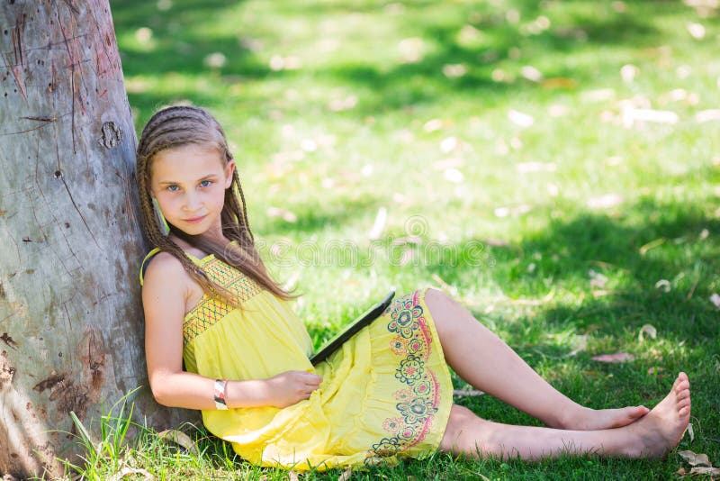 Cute little girl learning with tablet pc