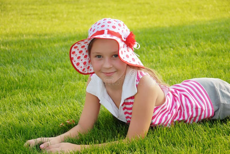 Cute Little Girl Lying on Grass Stock Image - Image of cheerful, face ...