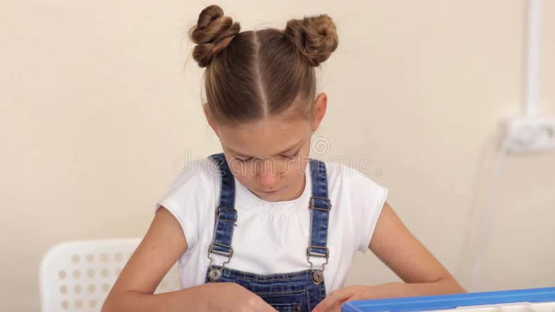 Cute little girl makes the lego toy slow motion