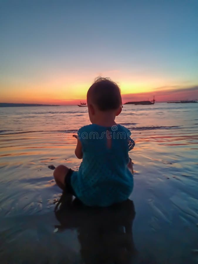 Cute little girl meet the sunset and having fun on the beach royalty free stock photo Cute little girl meet the sunset and having fun on the beach royalty free stock photo
