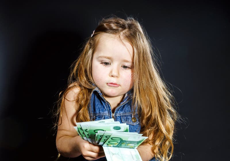 Cute little girl with money euro in her hand.