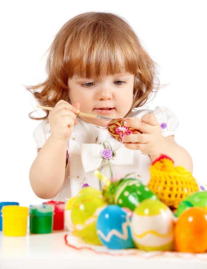 Cute little girl painting Easter eggs