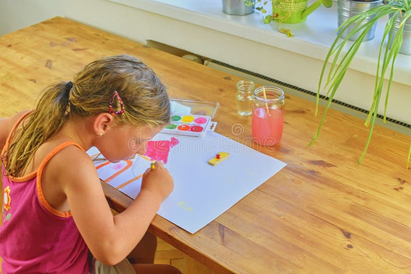 Cute little girl painting picture of house. Mortage concept. Selective focus, small DOF stock photos Cute little girl painting picture of house. Mortage concept. Selective focus, small DOF stock photos