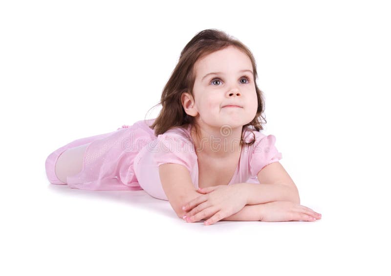 Cute little girl in a pink lie on the floor