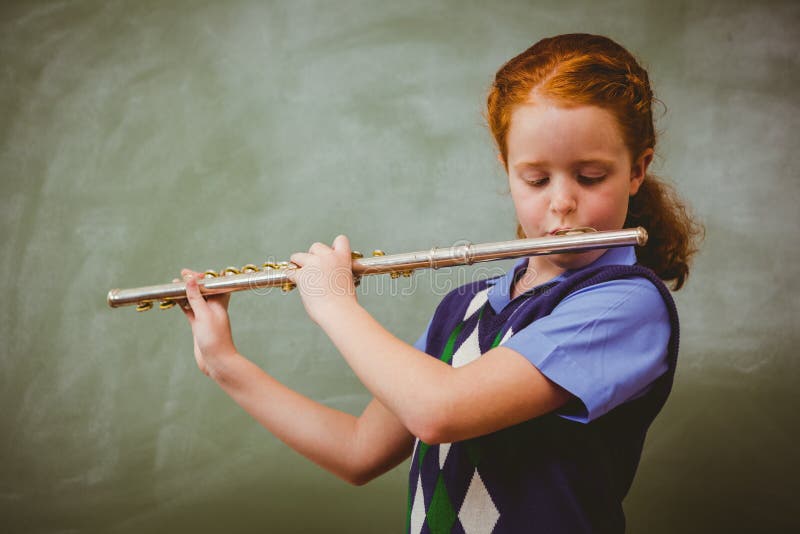 Playing flute. Игра на флейте. Ребенок флейтист. Девочка с флейтой.