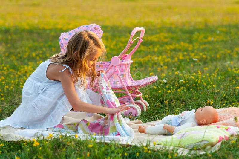 Cute little girl playing with her baby toy