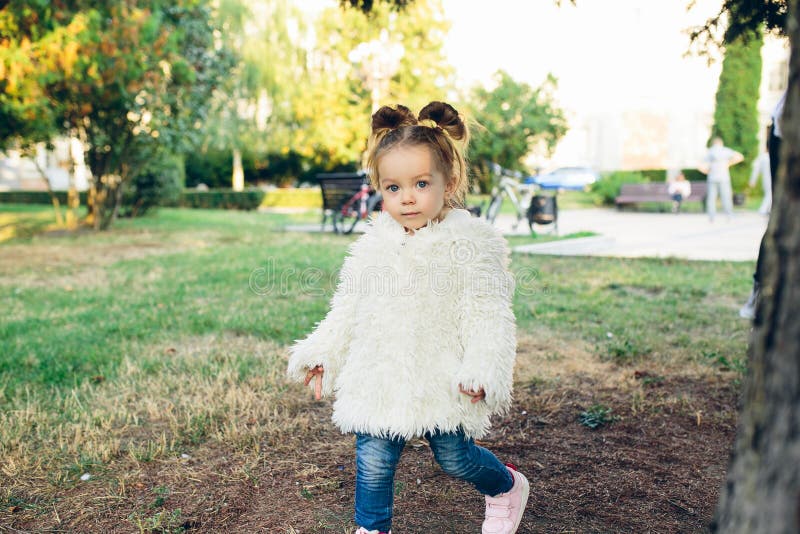 Cute little girl is playing hide and seek outdoors. Cute little girl is playing hide and seek outdoors