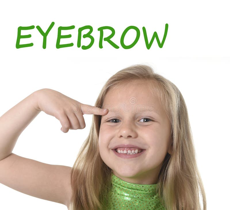 Cute little girl pointing her eyebrow in body parts learning English words at school royalty free stock image Cute little girl pointing her eyebrow in body parts learning English words at school royalty free stock image