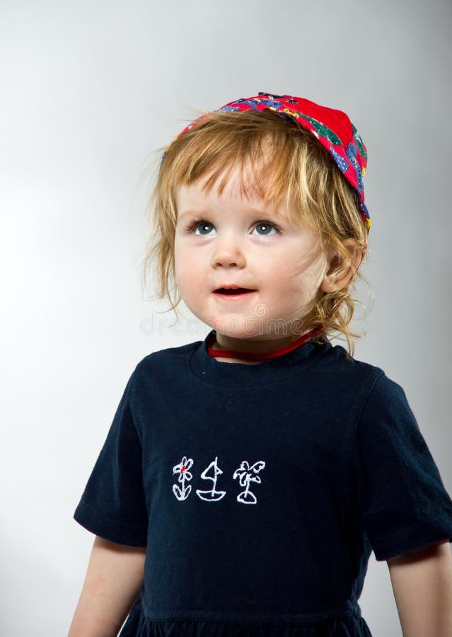 Cute little girl posing in red hat