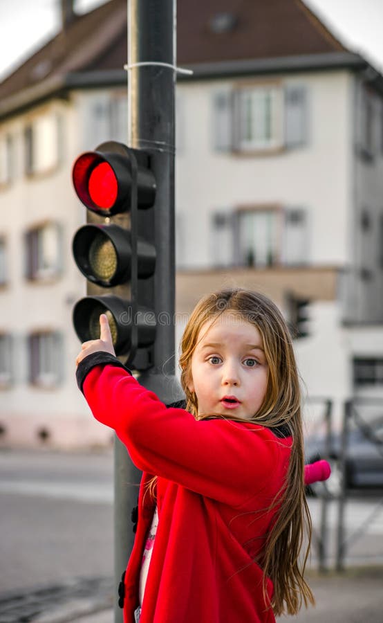Cute little girl posing with small traffic light royalty free stock photo