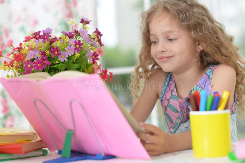 Little girl reading book