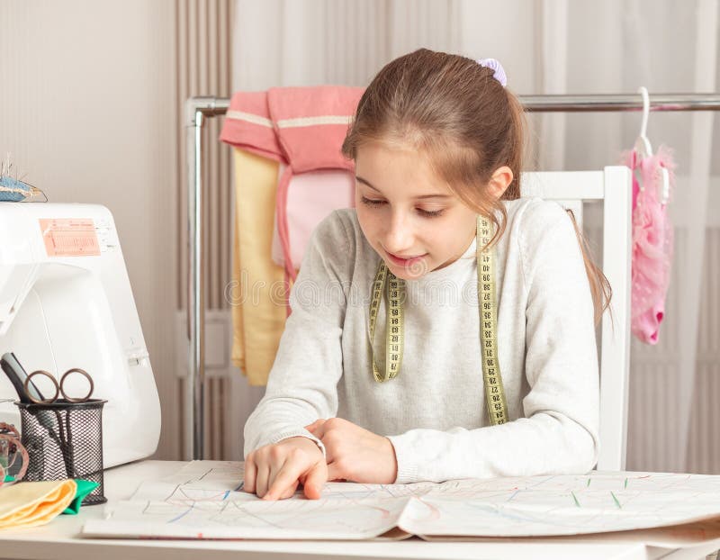 Little girl in a sewing workshop royalty free stock photography