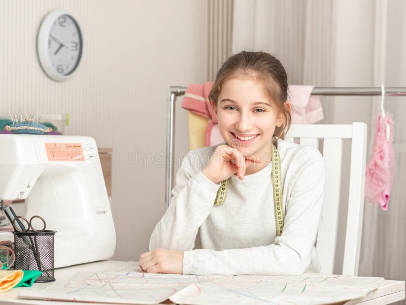 Little girl in a sewing workshop royalty free stock image