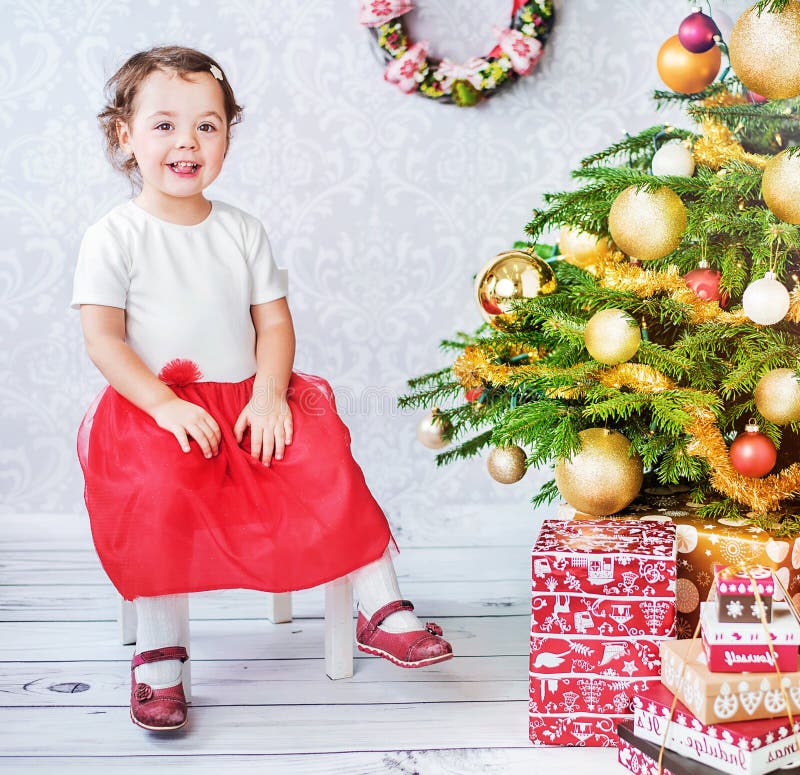 Cute Little Girl Sitting Nesxt To the Christmas Tree Stock Image ...