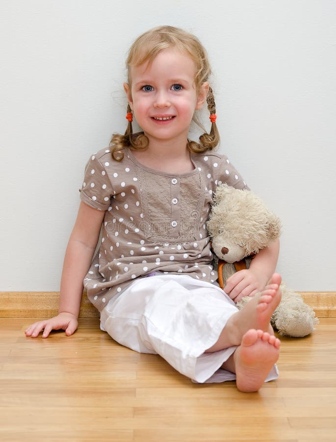 Cute little girl sitting with teddy bear