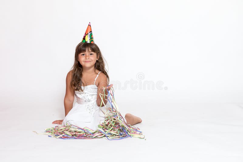 Cute little girl is sitting on the white background
