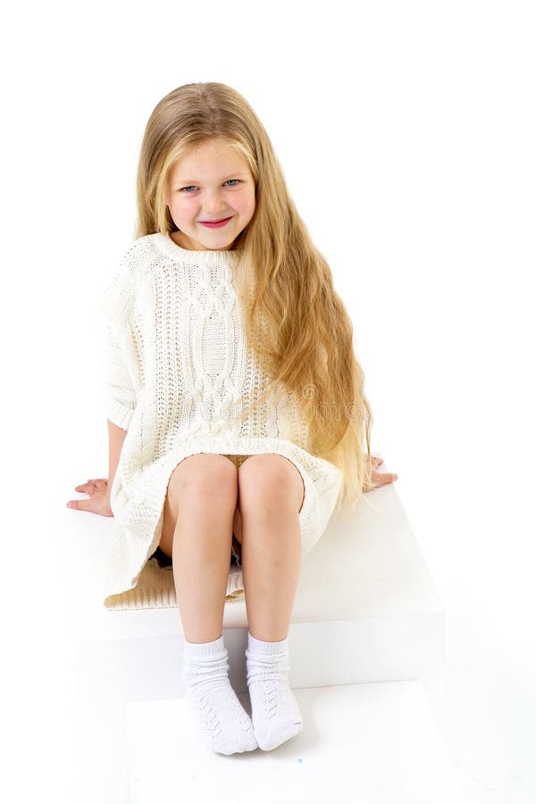 Cute little girl sitting on white staircase