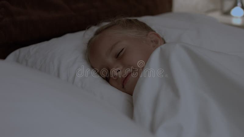 Cute little girl sleeping in her bed