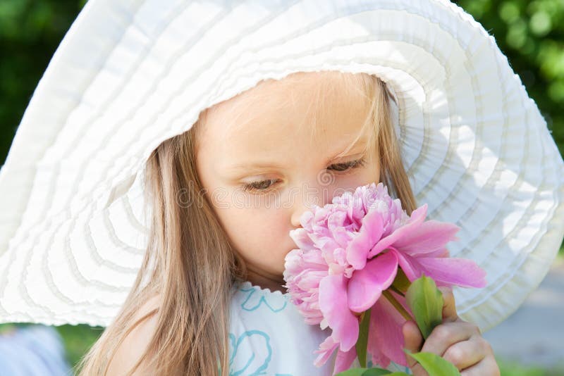 Cute little girl smelling a flower royalty free stock images Cute little girl smelling a flower royalty free stock images